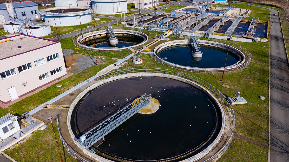 Municipal wastewater treatment facility with circular sedimentation tanks under daylight