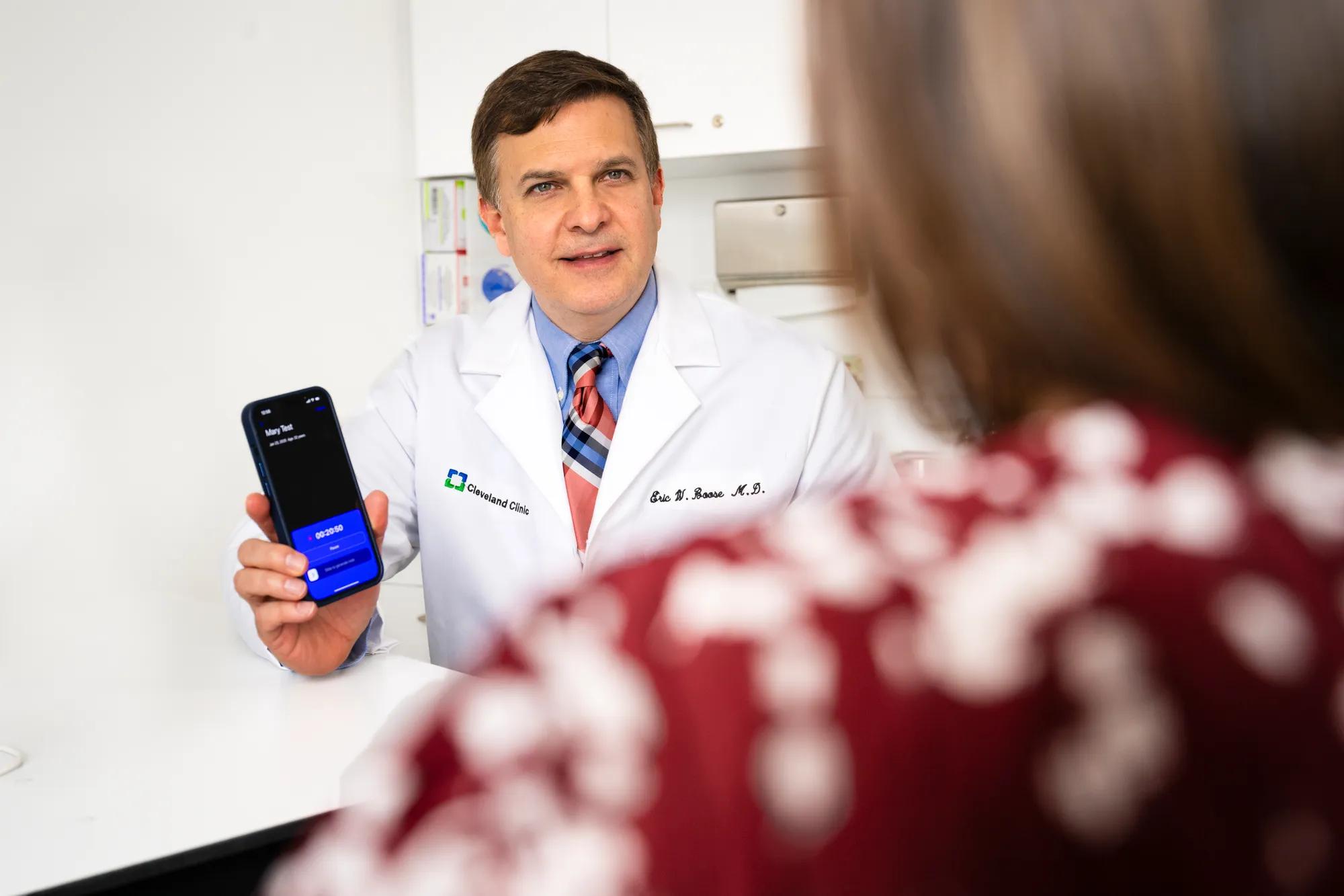 Clinician and patient in an exam room during a Cleveland Clinic ambient AI documentation workflow