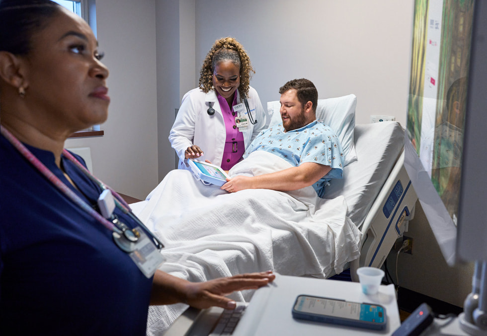Physician beside a patient at Emory Hillandale Hospital with an iPad mounted in the clinical room