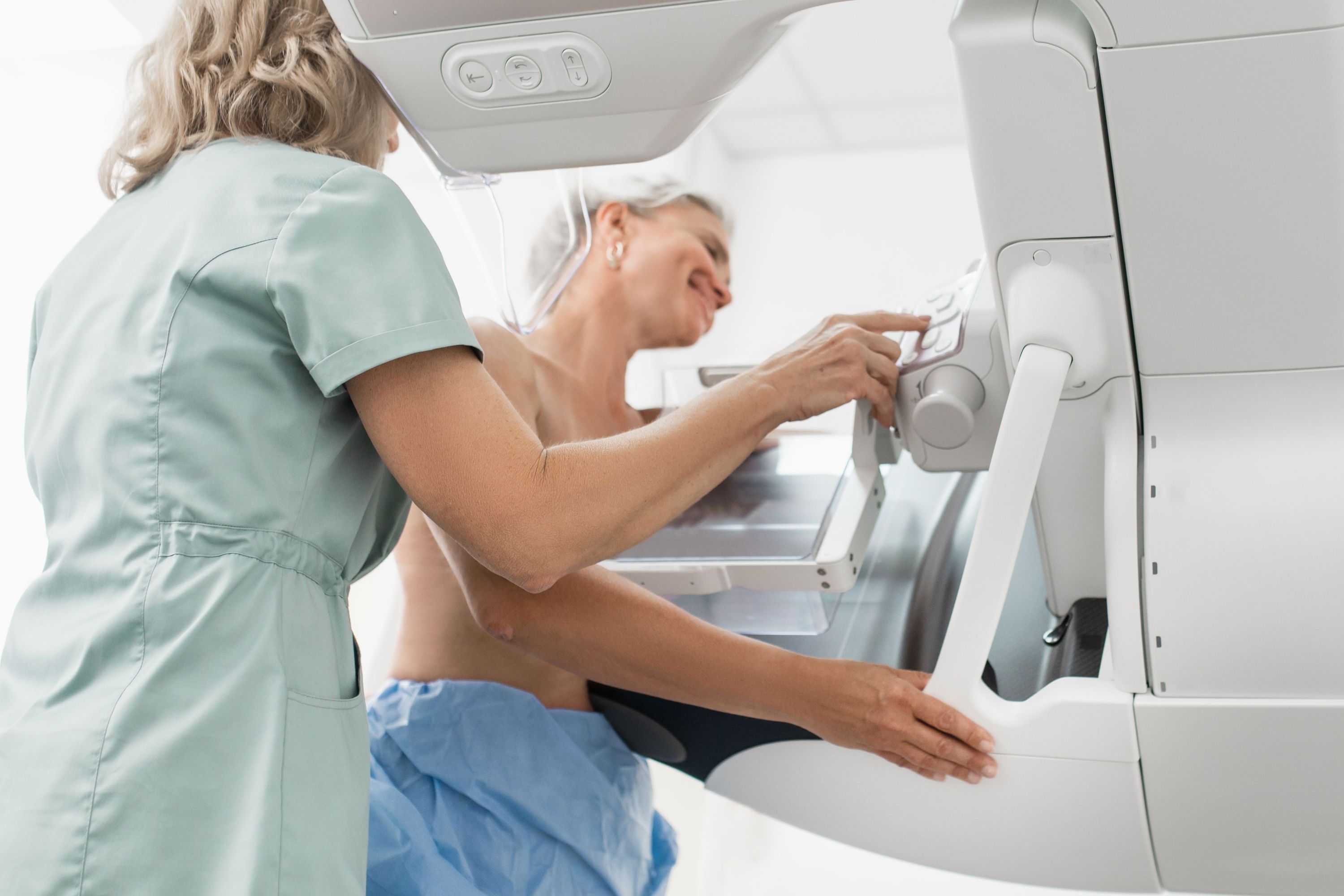 Mammography screening image on a medical monitor with AI analysis overlays in a radiology workstation